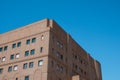 Generic red brick office building with perfect blue skies in the background Royalty Free Stock Photo