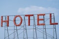 Generic red neon sign for a hotel, against a blue sky Royalty Free Stock Photo