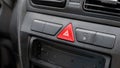 Generic red triangle emergency stop hazard lights button on a car dashboard, car interior object detail closeup, nobody. Vehicle Royalty Free Stock Photo