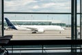 Generic regional flight airplane as seen from inside generic international airport terminal taxi towards runway