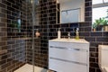 Generic shower room with glass black tiles