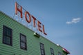 Generic sign for a Hotel on the top of a building. Artistic angle against blue sky Royalty Free Stock Photo