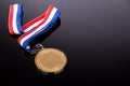 Generic sporting event gold medal with red and blue ribbon Royalty Free Stock Photo