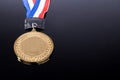 Generic sporting event gold medal with red and blue ribbon Royalty Free Stock Photo