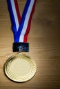 Generic sporting event gold medal with red and blue ribbon Royalty Free Stock Photo