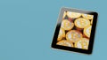 Generic Tablet showing stacks of golden Bitcoins