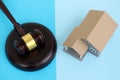 Generic toy house and judgement mallet on blue background Royalty Free Stock Photo