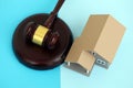 Generic toy house and judgement mallet on blue background Royalty Free Stock Photo
