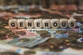 Generous - cube with letters, money sector terms - sign with wooden cubes