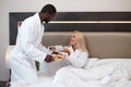 Generous kind man brought breakfast to bed to his beloved girlfriend