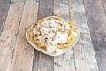 Generous portion of fried potatoes with stewed chicken and cesar sauce