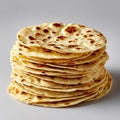 A tall stack of freshly cooked flatbreads with golden brown spots isolated on white background Royalty Free Stock Photo