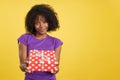Generous woman with afro hair giving a present