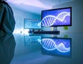 Genetic research data analysis on computer screens reflecting off surface in lab Royalty Free Stock Photo