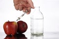 Genetically modified foods, apple pumped with chemicals Royalty Free Stock Photo