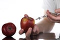 Genetically modified foods, apple pumped with chemicals Royalty Free Stock Photo