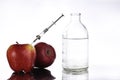 Genetically modified foods, apple pumped with chemicals Royalty Free Stock Photo