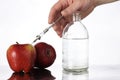 Genetically modified foods, apple pumped with chemicals Royalty Free Stock Photo