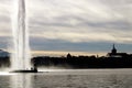 Geneva cityscape Water jet dEau Fountain and Saint-Pierre Cathedral silhouette in winter Royalty Free Stock Photo