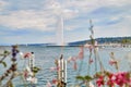 Geneva, Switzeland - September 21, 2018: Panoramic view on famous Jet d`Eau fountain through flowers in a nice day Royalty Free Stock Photo