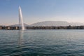 Geneva, Switzerland - April 15, 2019: Beautiful view of the water jet fountain in the lake of Geneva and the cityscape Royalty Free Stock Photo