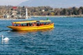 Geneva, Switzerland - April 14, 2019: View of a yellow and red Mouettes Genevoises Navigation boat, a public transport boat Royalty Free Stock Photo