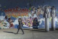 GENEVA, SWITZERLAND - FEBRUARY, 2019 - Woman walk near the mural of the Grottes school playground adjacent to Jean-Robert-Chouet t