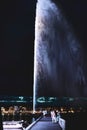 Night view of the Jet d\'Eau, a large fountain in Geneva, Switzerland and is one of the city Royalty Free Stock Photo