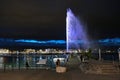 Night view of the Jet d\'Eau, a large fountain in Geneva, Switzerland and is one of the city Royalty Free Stock Photo