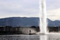 Geneva in winter Water jet deau Water Fountain and mountain Mont Saleve Royalty Free Stock Photo