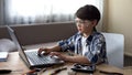 Genius child in safety glasses searching online instructions to PC details