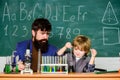 Genius kid. Joys and challenges raising gifted child. Teacher bearded scientist man child test tubes. Chemical