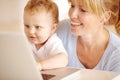 IT genius in the making. Beautiful mother helping her little baby boy type on her laptop computer. Royalty Free Stock Photo