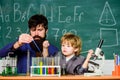 Genius minds. Genius toddler private lesson. Genius kid. Teacher child test tubes. Chemical experiment. Achieving Royalty Free Stock Photo