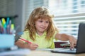 Genius nerd pupil child has idea. Child writing at school. School boy doing homework writing and reading at home Royalty Free Stock Photo