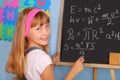 Genius schoolgirl writing on blackboard Royalty Free Stock Photo