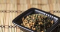 Genmaicha tea in black plate Royalty Free Stock Photo