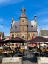 View over square on tower of former dutch medieval town hall against blue sky in summer