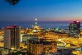 Genoa, Italy: industrial area near the port with Lanterna and commercial skyscrapers at night Royalty Free Stock Photo