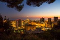 Genoa, Italy, industrial area near the port with Lanterna and commercial skyscrapers at night. Royalty Free Stock Photo
