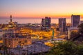 Genoa, Italy, industrial area near the port with Lanterna and commercial skyscrapers at sunset. Royalty Free Stock Photo