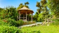 Genoa, Italy. In the Municipal Park of Nervi Gropallo, a hidden wooden gazebo immersed in the garden, near a nature trail Royalty Free Stock Photo