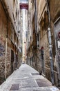 Genoa, Italy, 10/04/2019: Narrow street in the center of the old city. Traditional european architecture.