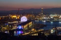 Aerial view of Genoa, Italy at night, the harbor with the Lanterna, the lighthouse,  symbol of Royalty Free Stock Photo