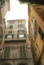 Buildings with hanging laundry at historic center of Genoa city