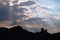 Genoese fortress silhouette with blue sky and clouds