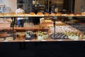 View through diplay window into typical belgian bakery with cakes, sweets and bread Royalty Free Stock Photo