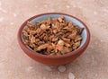 Gentian root in a small bowl on a marble table Royalty Free Stock Photo