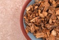 Gentian root in a small bowl on a marble table Royalty Free Stock Photo