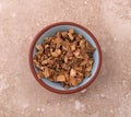 Gentian root in a small bowl on a marble table Royalty Free Stock Photo